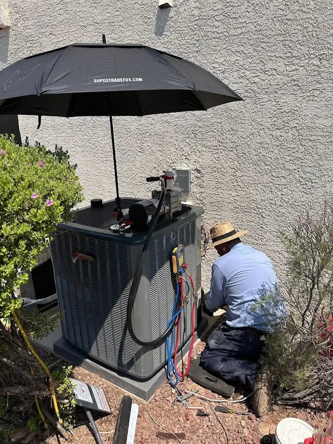 HVAC technician performing outdoor AC maintenance in Moberly